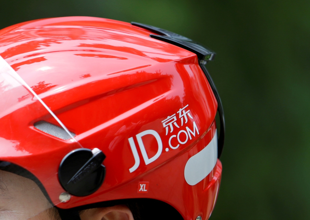 FILE PHOTO: A logo of JD.com is seen on a helmet of a delivery man in Beijing, China June 16, 2014. Picture taken June 16, 2014. REUTERS/Jason Lee/File Photo