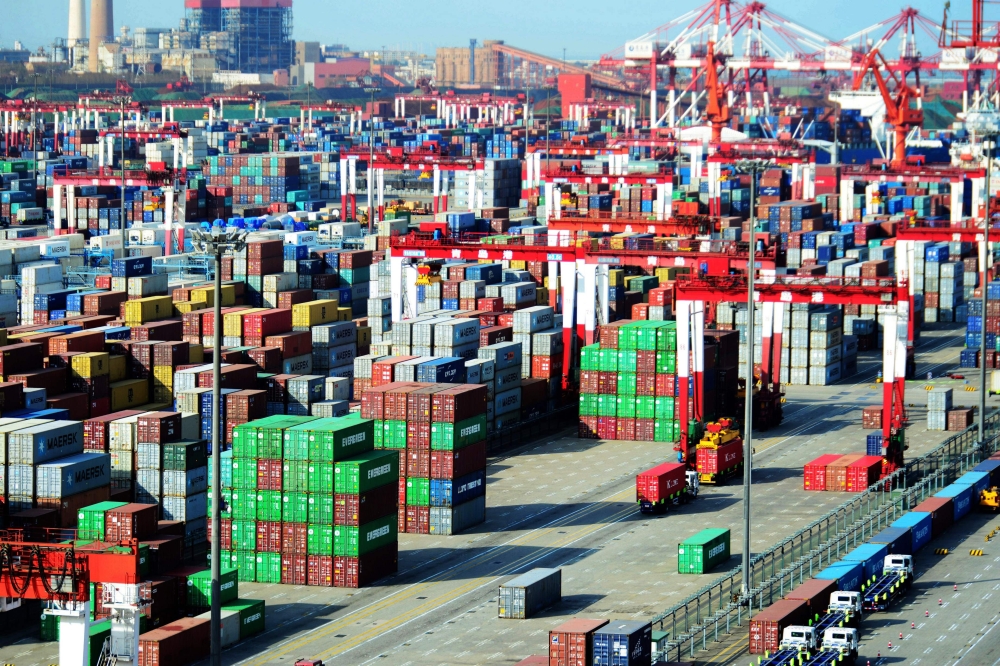 (FILES) This file picture taken on April 13, 2018 shows shipping containers transferred at a port in Qingdao, in China's eastern Shandong province. China OUT / AFP /