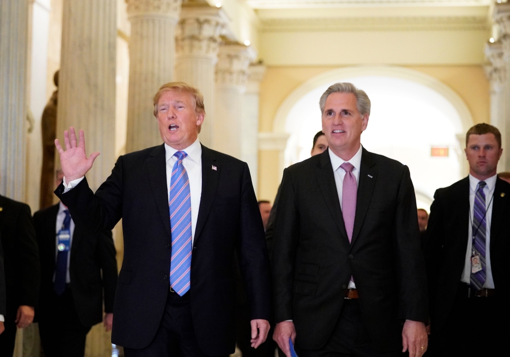 US President Donald Trump (L) walks next to US House Majority Leader Kevin McCarthy (R-CA) after a meeting at the US Capitol with the House Republican Conference in Washington, DC on June 19, 2018. AFP / Mandel Ngan