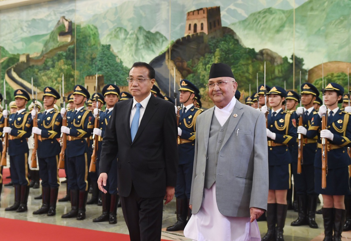 Nepal's Prime Minister K.P. Sharma Oli (center R) reviews a military honour guard with Chinese Premier Li Keqiang during a welcome ceremony at the Great Hall of the People in Beijing on June 21, 2018. AFP / Greg Baker