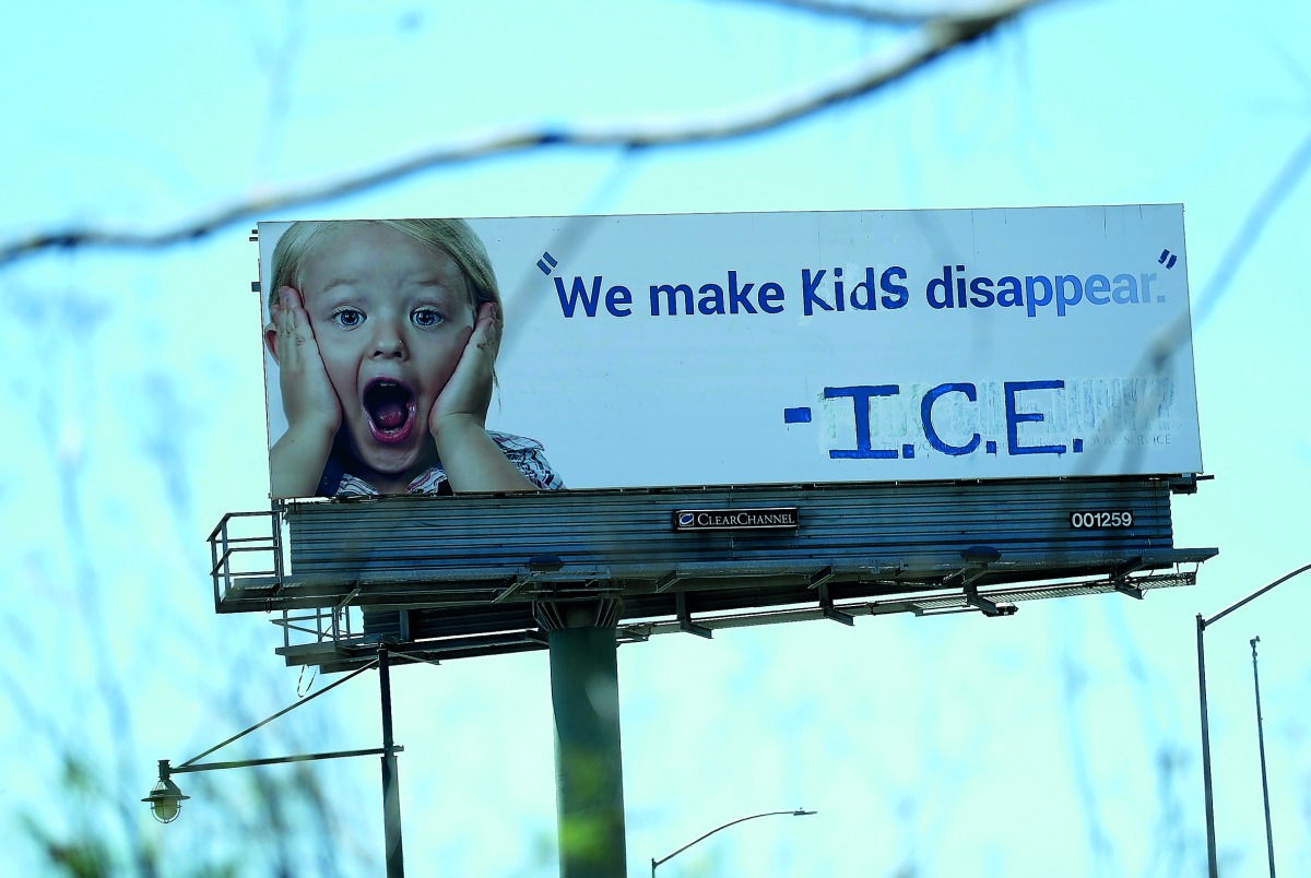 A vandalized 1-800-GOT-JUNK billboard shows a message in in protest with the Immigration and Customs Enforcement (ICE) and their participation in separating children from their parents trying to enter the U.S. from Mexico on June 21, 2018 in Emeryville, C