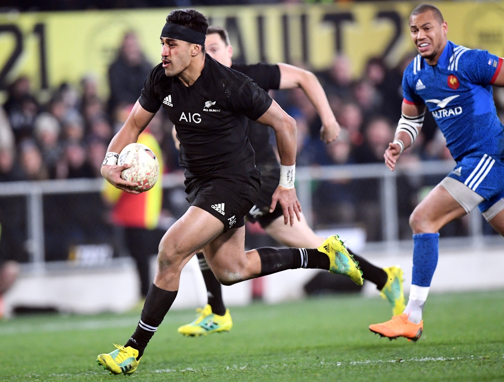 Reiko Ioane of New Zealand runs away from Gael Fickou of France. REUTERS/Ross Setford