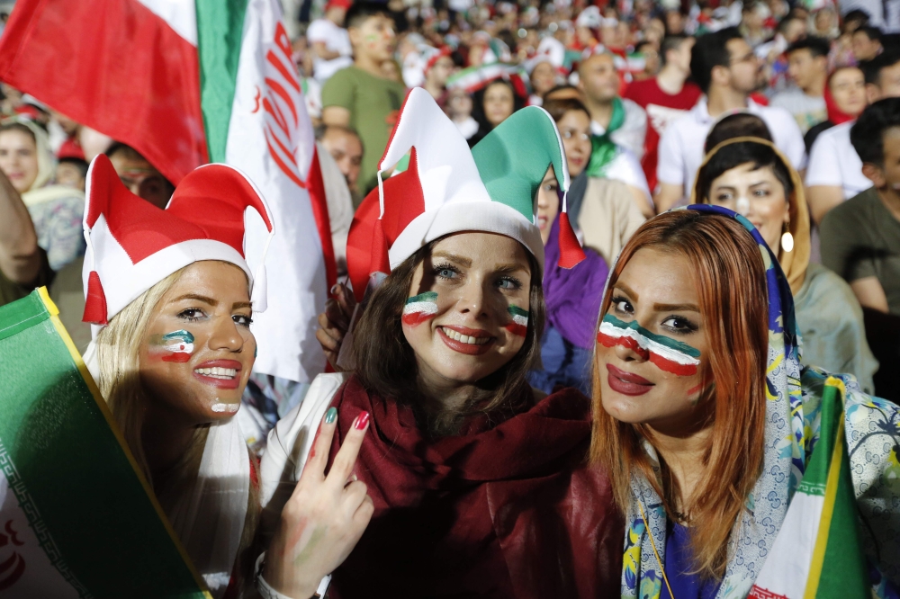 Iranian women watch the World Cup Group B soccer match between Portugal and Iran at Azadi stadium in Tehran on June 25, 2018. / AFP / ATTA KENARE 