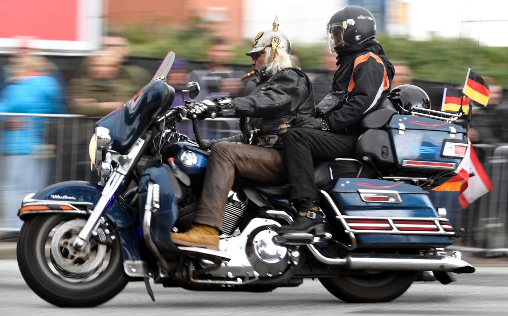 A biker rides his Harley-Davidson during a parade at the 