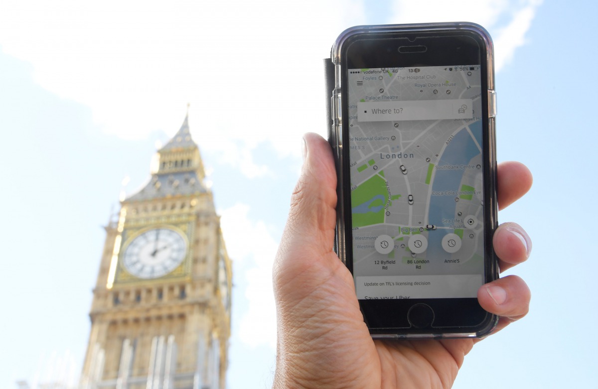 A photo illustration shows the Uber app on a mobile telephone, as it is held up for a posed photograph in central London, Britain, September 22, 2017. (Reuters / Toby Melville) 