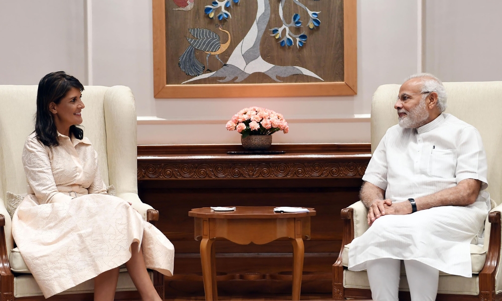 In this handout photograph released by India's Press Information Bureau (PIB) on June 27, 2018, US Ambassador to the United Nations Nikki Haley (L) and Indian Prime Minister Narendra Modi look on in New Delhi. AFP / PIB