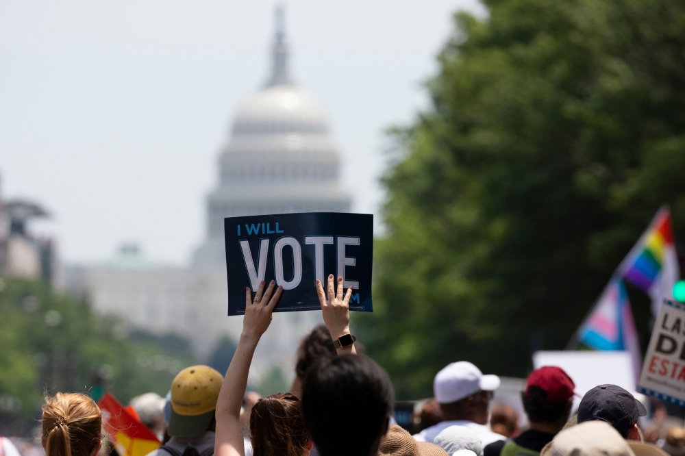 Demonstrators march against the separation of immigrant families, on June 30, 2018 in Washington, DC. Demonstrations are being held across the US Saturday against President Donald Trump's hardline immigration policy. / AFP / Alex Edelman