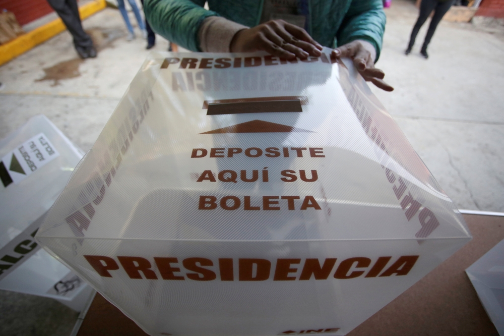A poll worker assembles a ballot box at a polling station for the presidential election in Mexico City, Mexico July 1, 2018. REUTERS/Daniel Becerril