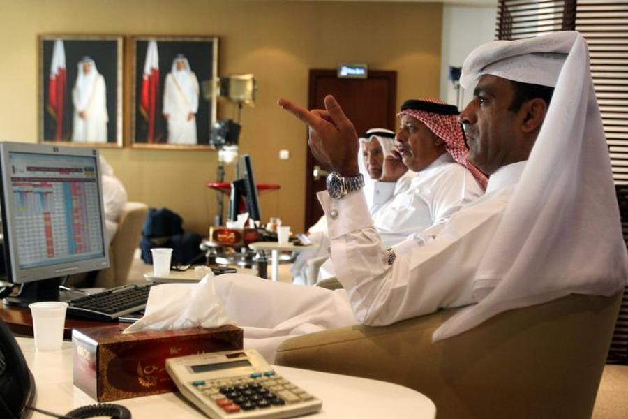 Traders monitor screens displaying stock information at Qatar Stock Exchange in Doha in this November 9, 2016 file photo. (Reuters / Naseem Zeitoon) 