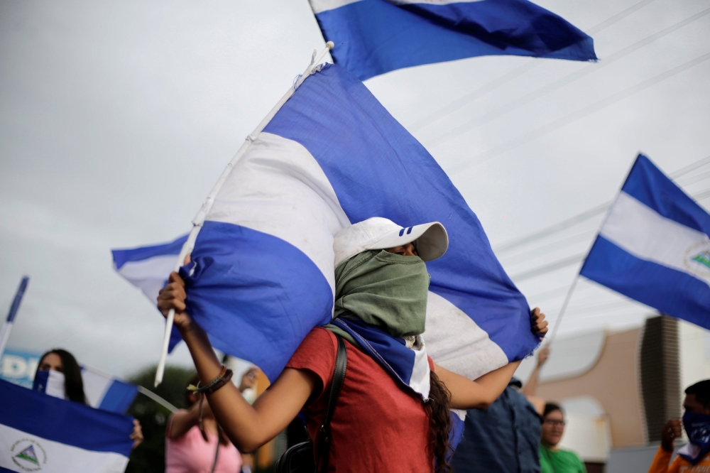 Demonstrators hold Nicaraguan national flags during a protest against President Daniel Ortega's government in Managua, Nicaragua, July 3, 2018. REUTERS/Jorge Cabrera