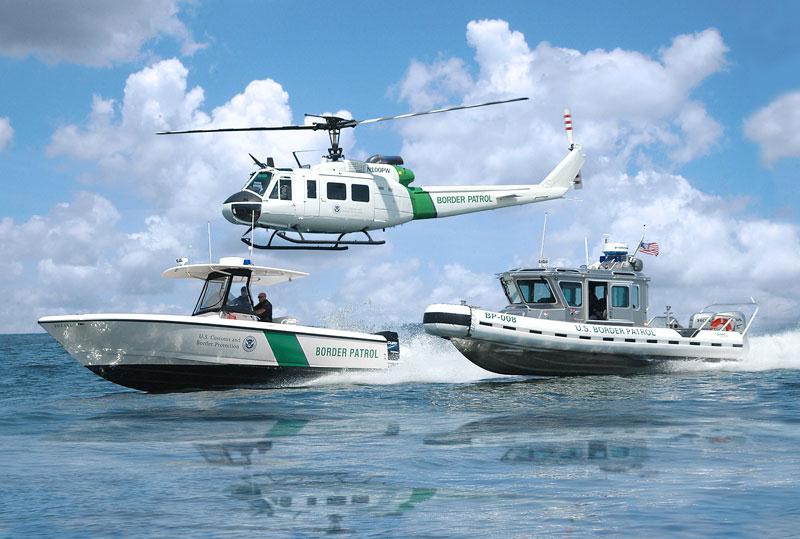 FILE PHOTO: CBP Air and Marine Intrepid and SafeBoat vessels accompanied on patrol by a UH-1 Huey near San Diego, CA..(Wikimedia Commons)