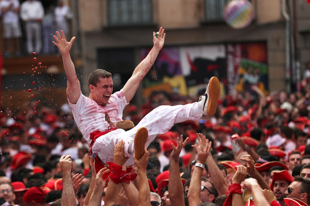 A reveller is thrown into air by others during the opening the San Fermin festival in Pamplona, Spain, July 6, 2018. Reuters/Susana Vera