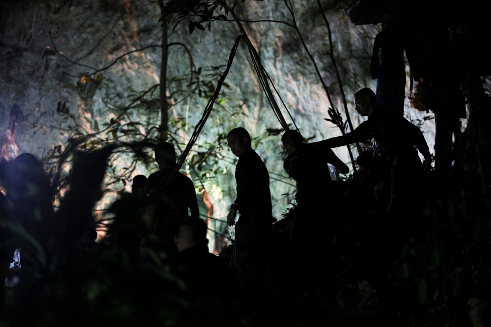 Military personnel are seen in front of the Tham Luang cave, where 12 boys and their soccer coach are trapped, in the northern province of Chiang Rai, Thailand, July 6, 2018. REUTERS/Athit Perawongmetha 