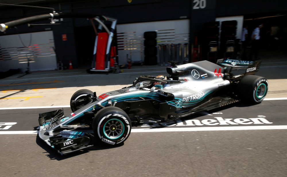 Mercedes' Lewis Hamilton drives in the pit lane during qualifying. (REUTERS/Andrew Yates)