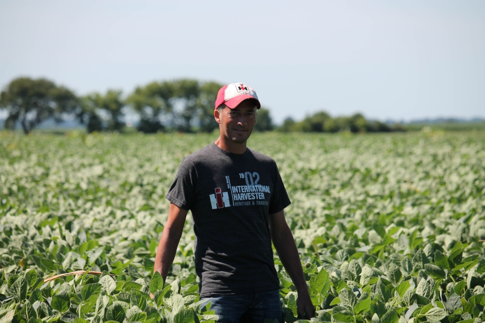 Farmer Terry Davidson walks through his soy fields July 6, 2018, in Harvard, Illinois, the same day China imposed retaliatory tariffs aimed at the US soybean market. AFP / Derek R. Henkle 