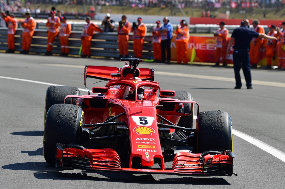 Ferrari's German driver Sebastian Vettel drives into the 'parc ferme' after the British Formula One Grand Prix at the Silverstone motor racing circuit in Silverstone, central England, on July 8, 2018. (AFP / Andrej ISAKOVIC)