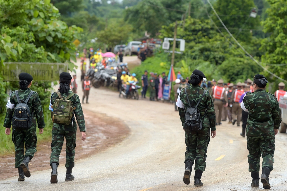 Thai military paramedics head the road to Tham Luang cave area while divers evacuate some of the 12 boys and their coach trapped in the flooded cave in Khun Nam Nang Non Forest Park in the Mae Sai district of Chiang Rai province on July 8, 2018.  AFP / Ta