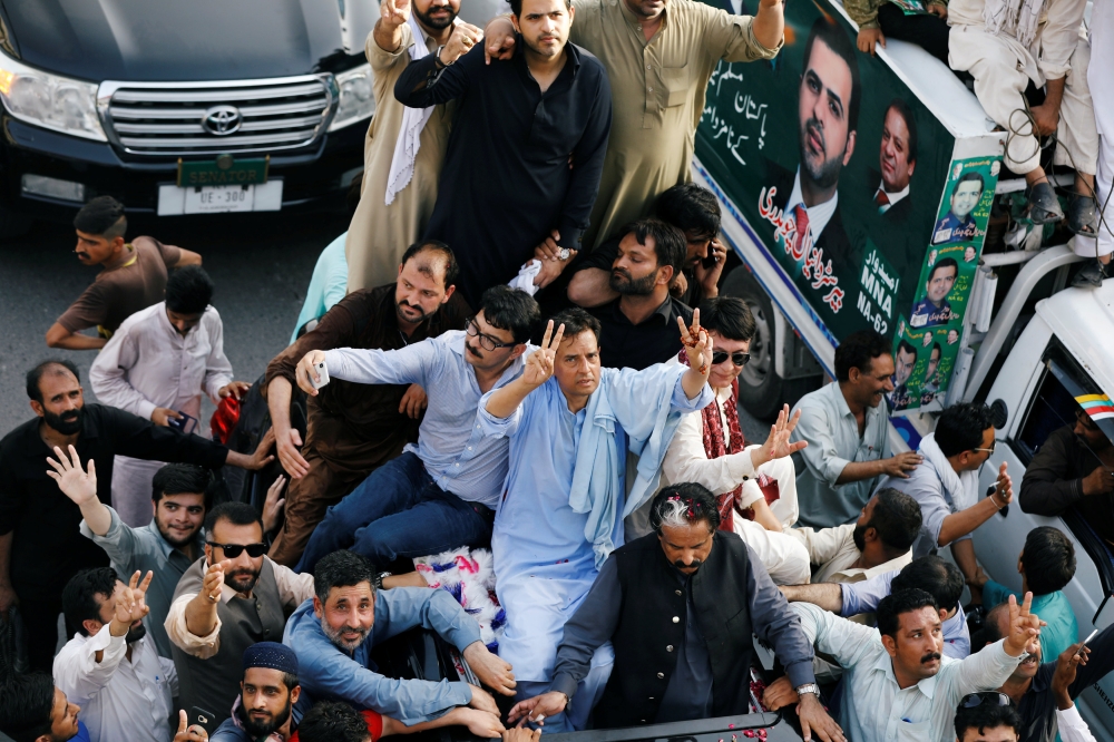 Muhammad Safdar, son-in-law of ousted Prime Minister Nawaz Sharif, waves to supporters while leading a rally before his arrest in Rawalpindi, Pakistan July 8, 2018. Reuters/Faisal Mahmood