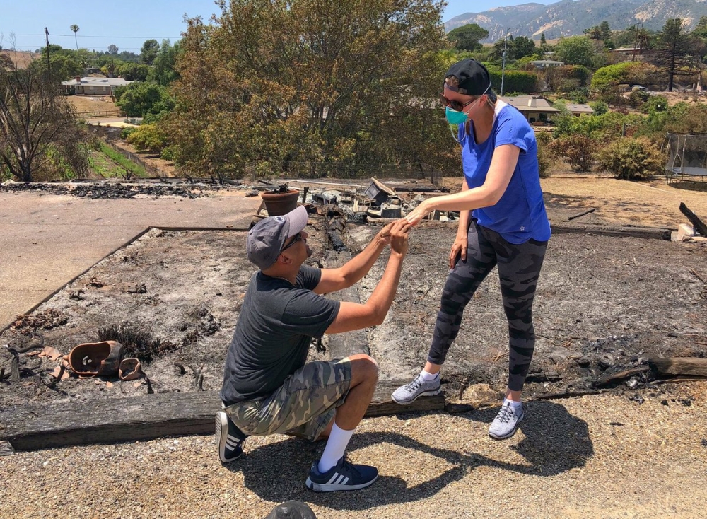 Ishu and Laura Rao, return to the rubble of their home which they lost in a wildfire, to retrieve their wedding ring, in Alameda, California, US, in this July 8, 2018 photo obtained from social media. Mike Eliason/Santa Barbara County Fire Department/via 