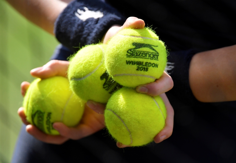 A ball boy holds balls during Reuters/Toby Melville