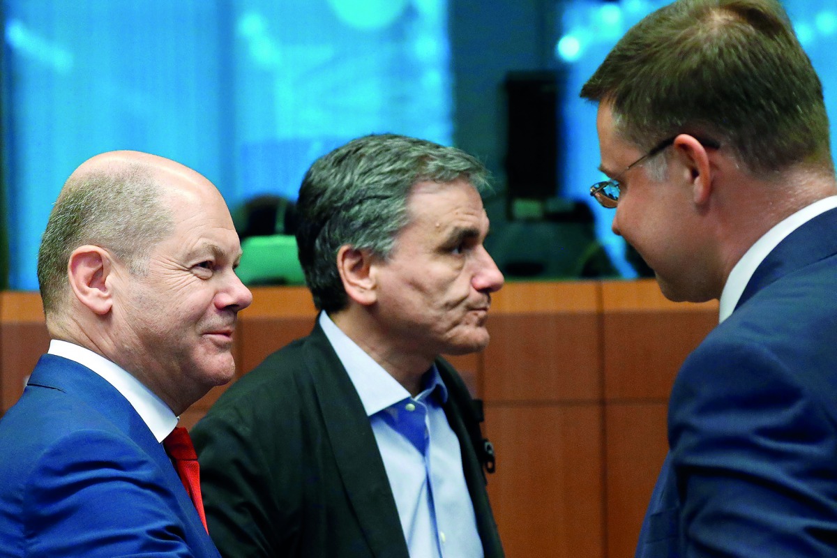 German Finance Minister Olaf Scholz, Greek Finance Minister Euclid Tsakalotos and European Commission Vice-President Valdis Dombrovskis attend an eurozone finance ministers meeting in Brussels, Belgium July 12, 2018. Reuters/Francois Lenoir

