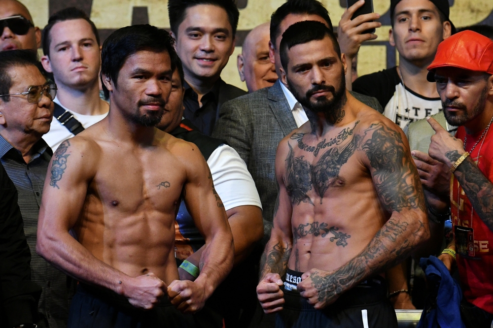 Manny Pacquiao (L) and Lucas Matthysse (R) pose during the weigh-in for their WBA welterweight championship fight in Kuala Lumpur, Malaysia July 14, 2018. REUTERS/Stringer