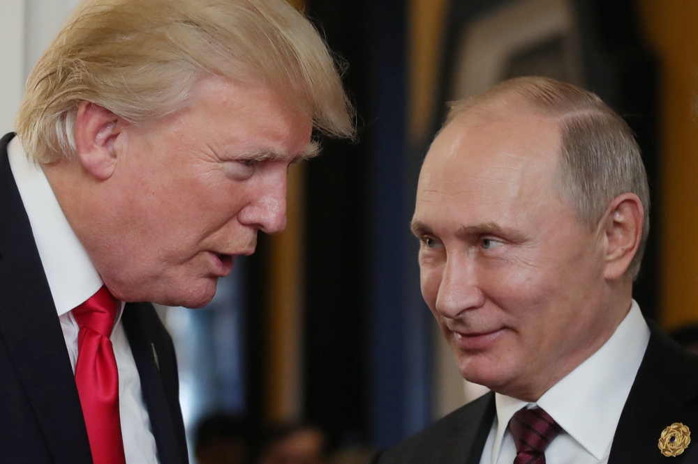 File photo of US President Donald Trump (L) chatting with Russia's President Vladimir Putin as they attend the APEC Economic Leaders' Meeting, part of the Asia-Pacific Economic Cooperation (APEC) leaders' summit in the central Vietnamese city of Danang, N