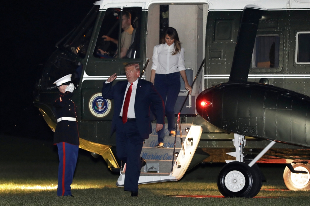 U.S. President Donald Trump salutes as he returns with First Lady Melania Trump to the White House in Washington, U.S. from Helsinki, Finland, July 16, 2018. REUTERS/Yuri Gripas