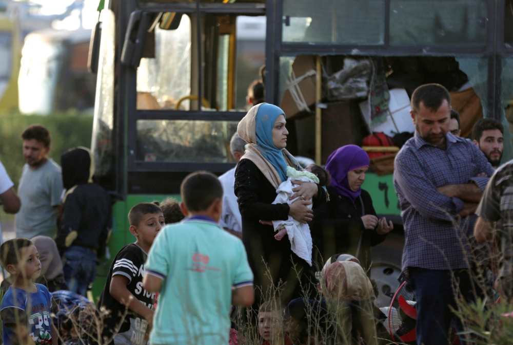 People are seen as they are evacuated from the villages of al-Foua and Kefraya, Syria July 19, 2018. Reuters/Khalil Ashawi