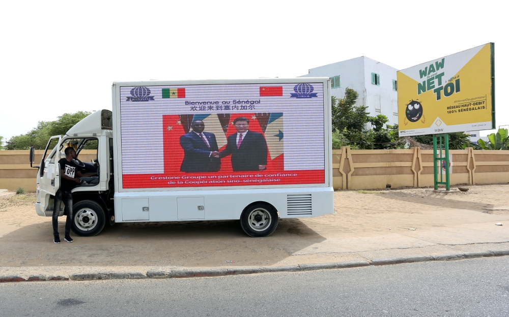 Chinese President Xi Jinping's visit to Senegal is advertised with posters printed across the side of a truck in Dakar, Senegal July 21, 2018. Reuters/Mikal McAllister