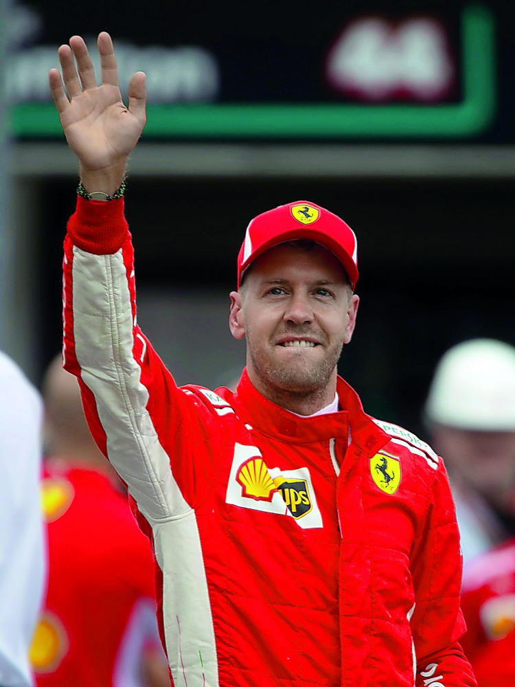 Ferrari's Sebastian Vettel celebrates after qualifying in pole position Reuters/Wolfgang Rattay
