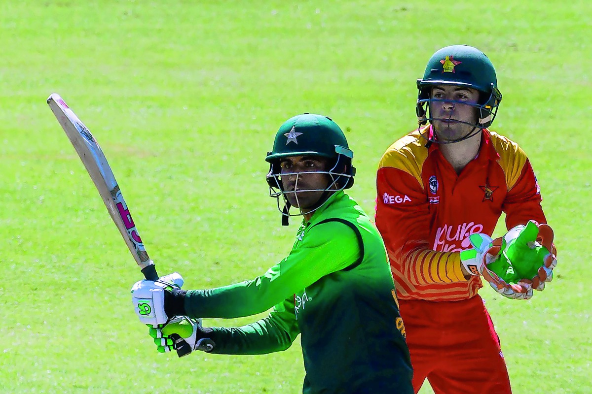 Pakistan's batsman Fakhar Zaman (L) prepares to play a shot next to Zimbabwe's wicket keeper Ryan Murray during the final cricket match of a five-match ODI series played between Pakistan and host Zimbabwe at Queens Sports Club in Bulawayo, on July 22, 201