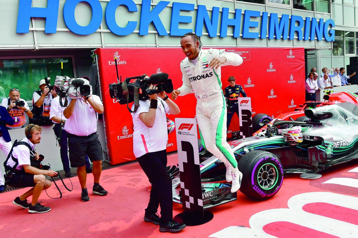 Mercedes' British driver Lewis Hamilton celebrates after winning the German Formula One Grand Prix at the Hockenheim racing circuit on July 22, 2018 in Hockenheim, southern Germany.  AFP / Andrej Isakovic


