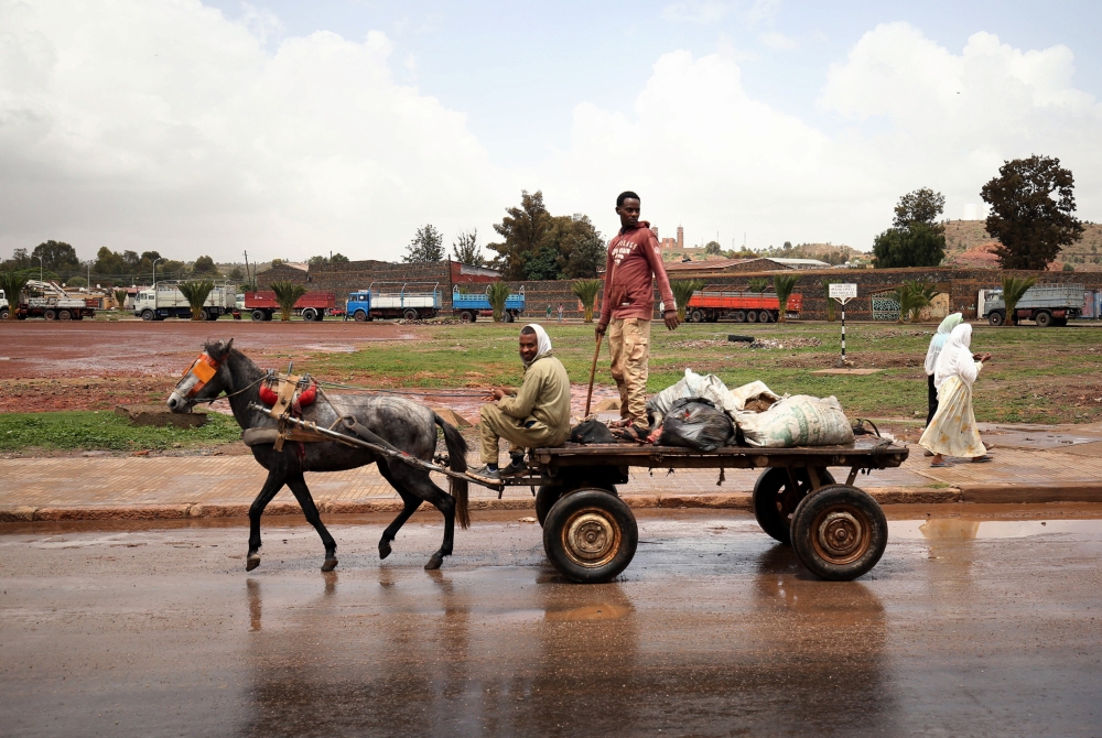 Men ride on a horse cart in the outskirts of Asmara, Eritrea July 21, 2018. Picture taken July 21, 2018. Reuters/Tiksa Negeri