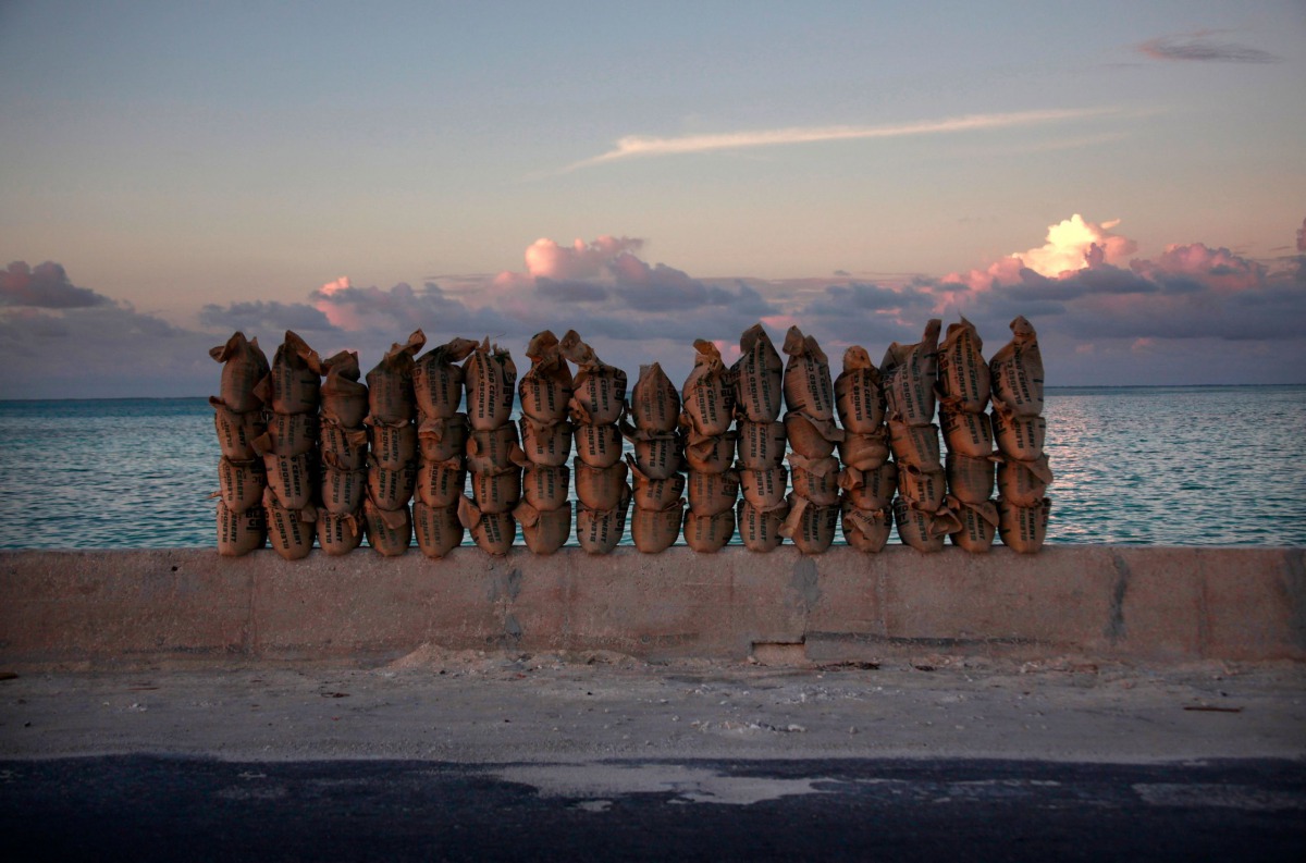 Newly made sandbags sit on a wall on a causeway that connects the town of Bairiki and Betio on South Tarawa in the central Pacific island nation of Kiribati, May 25, 2013. Reuters/David Gray