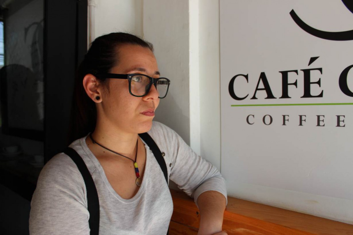 Andrea Rojas, a Venezuelan asylum seeker, poses for a portrait in front of the coffee shop where she works in Port of Spain, Trinidad and Tobago, May 23, 2018. Thomson Reuters Foundation/Gregory Scruggs