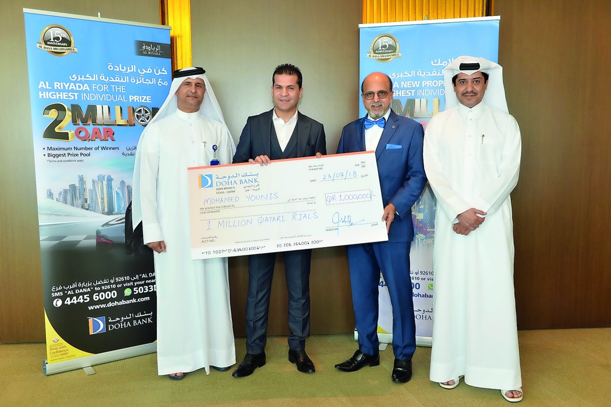 Dr R Seetharaman (second right), CEO of Doha Bank, and other officials handing over a big cheque template of QR1m to the winner of Doha Bank’s 63rd millionaire for Al Dana saving schemes.
