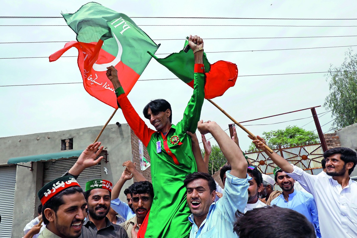 Supporters of Imran Khan, chairman of the Pakistan Tehreek-e-Insaf (PTI) party, celebrate a day after the general election, in Peshawar, Pakistan July 26, 2018. Reuters/Fayaz Aziz