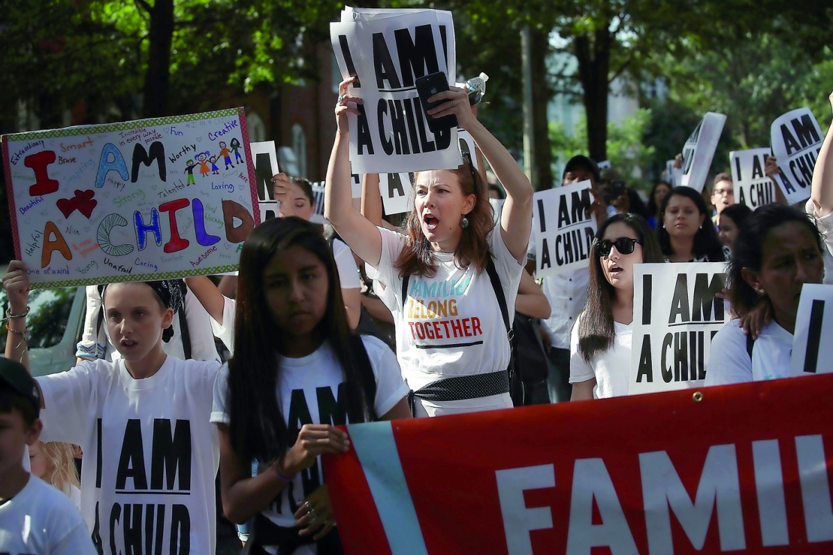 Protesters and their children participate in a march prior to a sit-in in the Hart Senate Office Building to mark the court-ordered deadline for the Trump Administration to reunify thousands of families separated at the border July 26, 2018 in Washington,