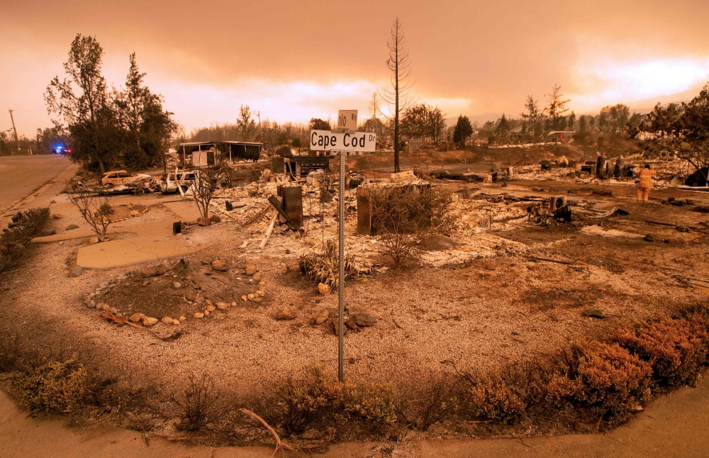Burned out properties are seen near the Lake Keswick Estates area during the Carr fire in Redding, California on July 27, 2018. Two firefighters have died and more than 100 homes have burned as wind-whipped flames tore through the region. (AFP / JOSH EDEL