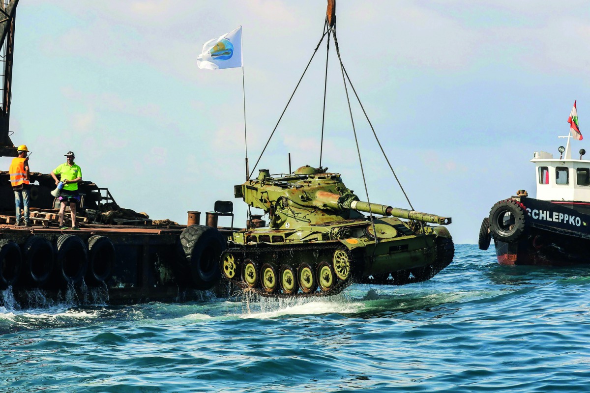 Environmental activists dropping off old battle tanks provided by the Lebanese Armed Forces to create new habitat for marine life into the Mediterranean Sea, about three kilometres off the coast of the southern Lebanese port city of Sidon, yesterday.