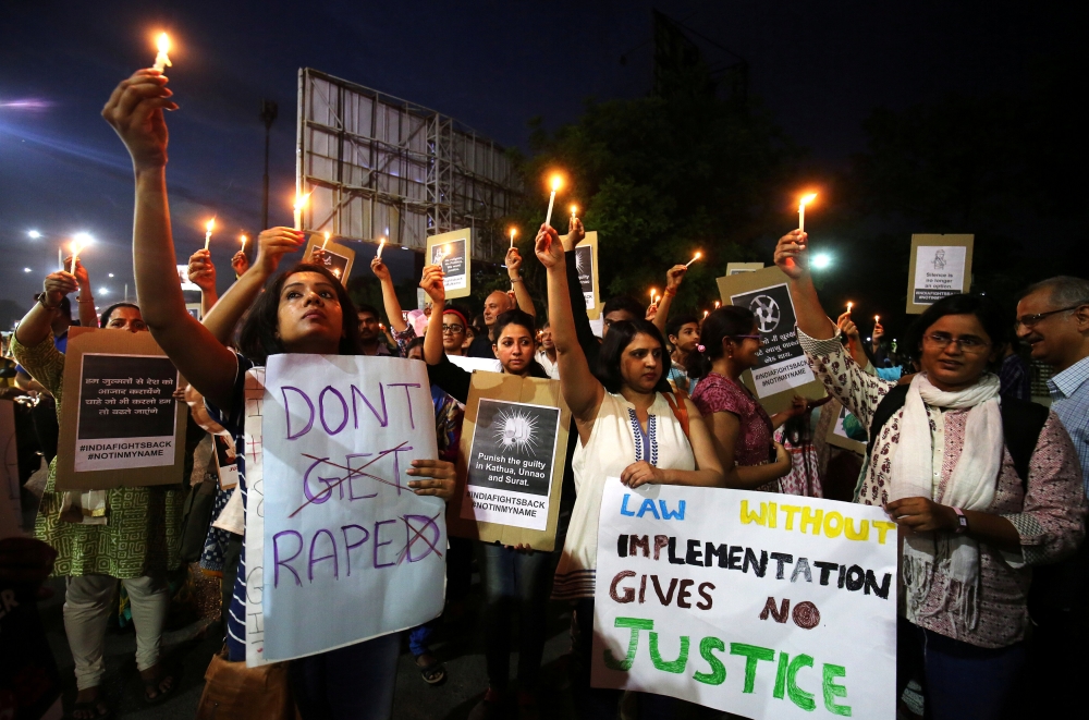 FILE PHOTO: People protest against the rape of an eight-year-old girl in Kathua near Jammu a teenager in Unnao, Uttar Pradesh and an eleven-year-old girl in Surat in Ahmedabad,  April 16, 2018. (Reuters / Amit Dave) 