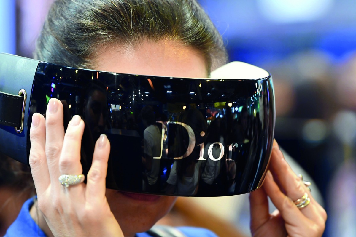 A woman uses a Dior virtual reality mask at the French multinational luxury goods group LVMH exhibition stand during the Vivatech fair ( (Viva Technology) in Paris. 