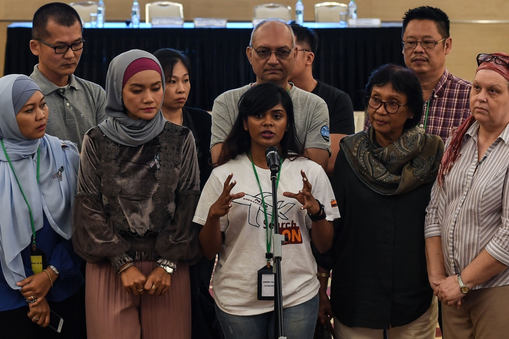 Grace Subathirai Nathan (C), daughter of missing Malaysia Airlines flight MH370 passenger Anne Daisy, speaks during a press conference after being presented with the final investigation report on the missing flight, in Putrajaya, outside Kuala Lumpur, on 