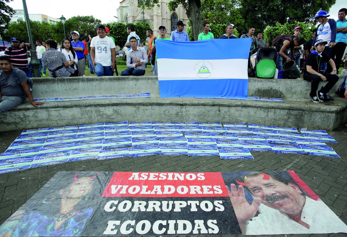 Nicaraguan refugees fleeing their country due to unrest display signs with the names of Nicaraguans who died during clashes with riot police in La Merced park in San Jose, Costa Rica, July 29,2018. Reuters/Juan Carlos Ulate

