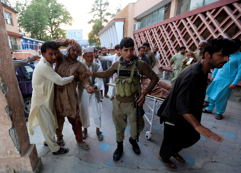 Men carry an injured man in a hospital after a suicide attack in Jalalabad, Afghanistan July 30, 2018. REUTERS/Parwiz