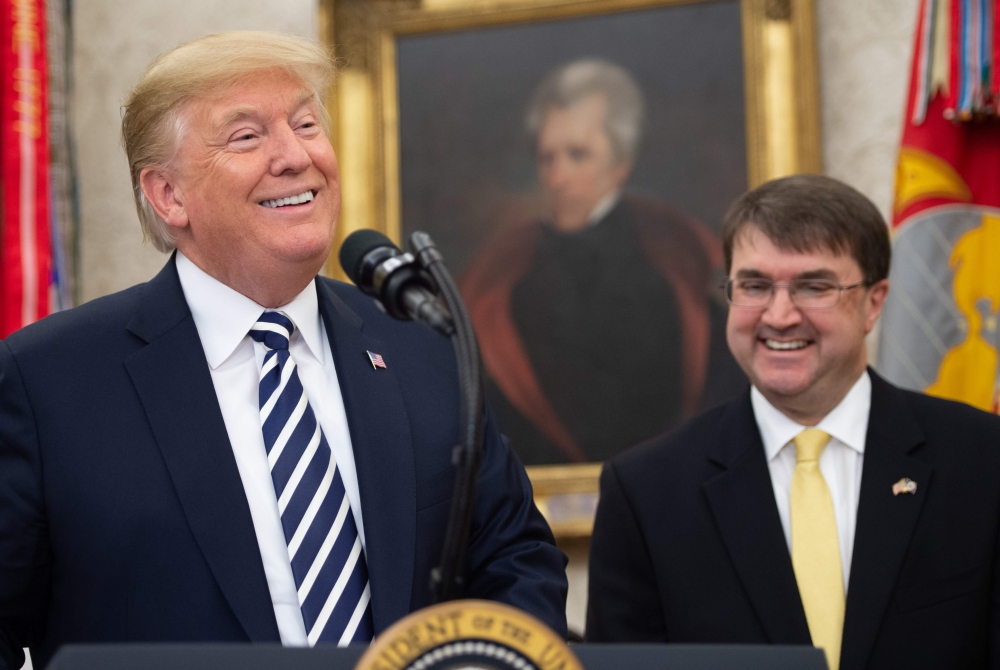 US President Donald Trump speaks during the swearing-in ceremony of Robert Wilkie (R) as Secretary of Veterans Affairs in the Oval Office of the White House in Washington, DC, July 30, 2018. (AFP / SAUL LOEB)