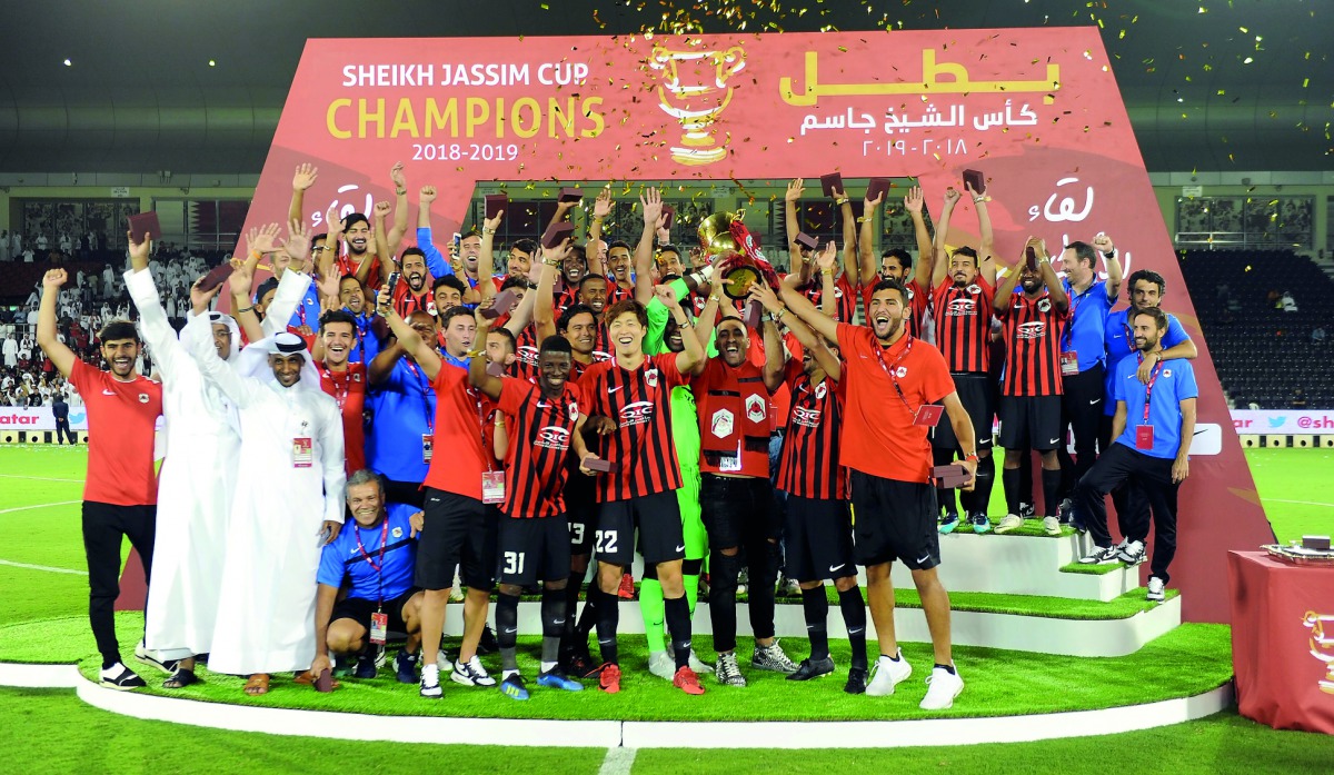 Al Rayyan players and officials celebrate with the Sheikh Jassim Cup Trophy after defeating Al Duhail at the Al Sadd Stadium yesterday. Pictures: Abdul Basit / The Peninsula 