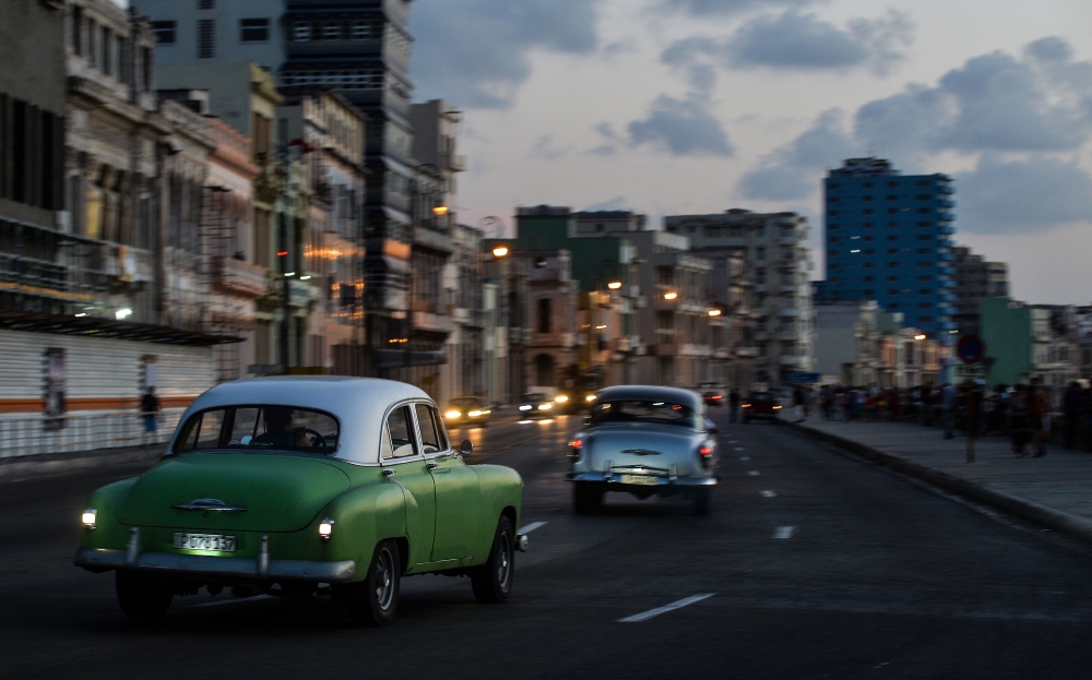 File photo of old American cars driving along Havana's Malecon on July 12, 2018.  / AFP / YAMIL LAGE