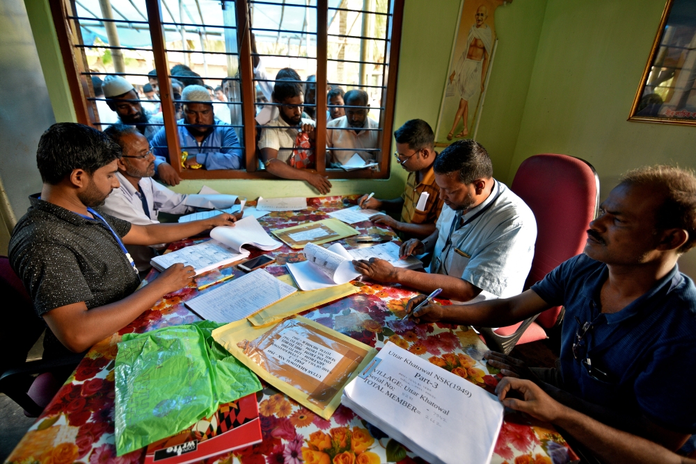  People wait to check their names on the draft list at the National Register of Citizens (NRC) centre at a village in Nagaon district, Assam state, India, July 30, 2018. Reuters